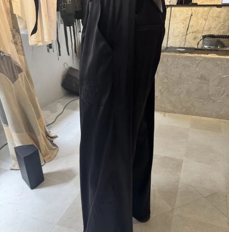 Satin wide-leg trousers — the phone photo of the sample in the store, used as source
